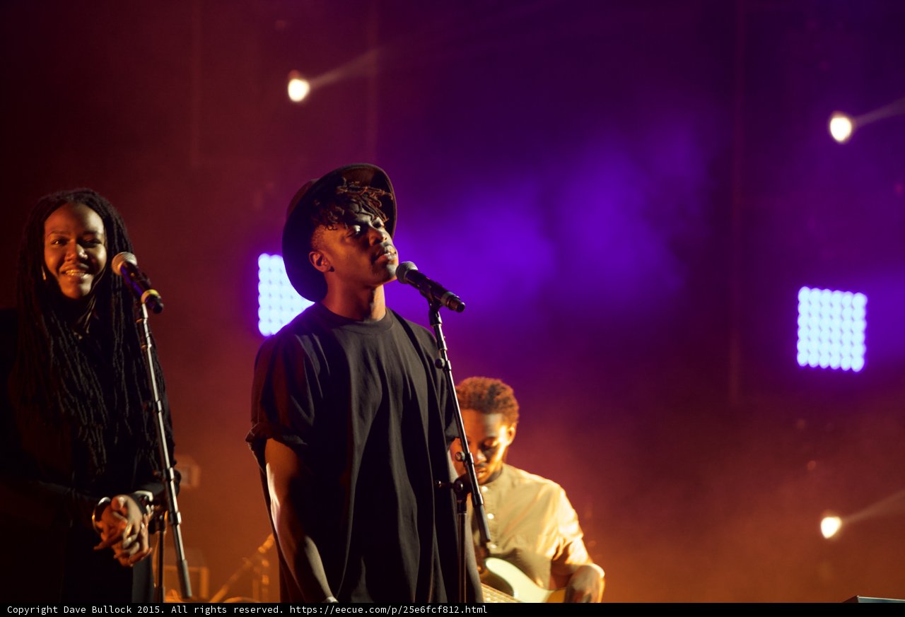 Solange Band Three Musicians Vocalist Hat Dreadlocks Bassist LED Panel Purple