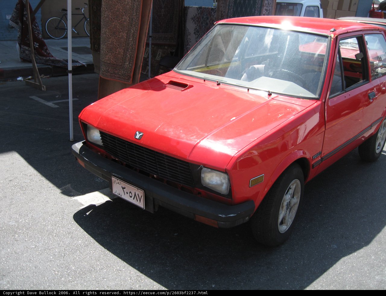 Red Coupe Parked on the Roadside