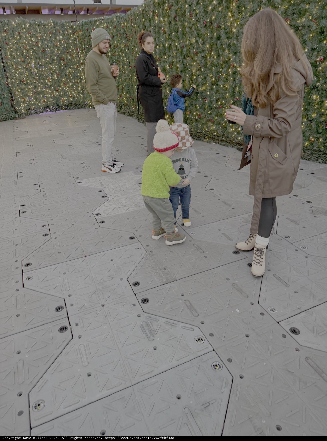 Family Enjoying Interactive Floor Display at Public Venue