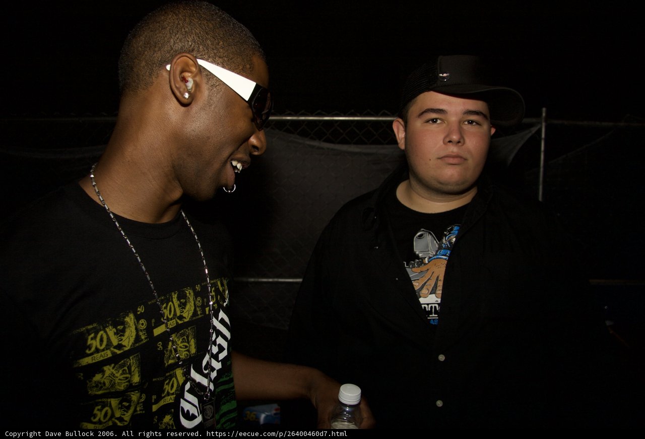 Two Men with Hats and Accessories at a Party
