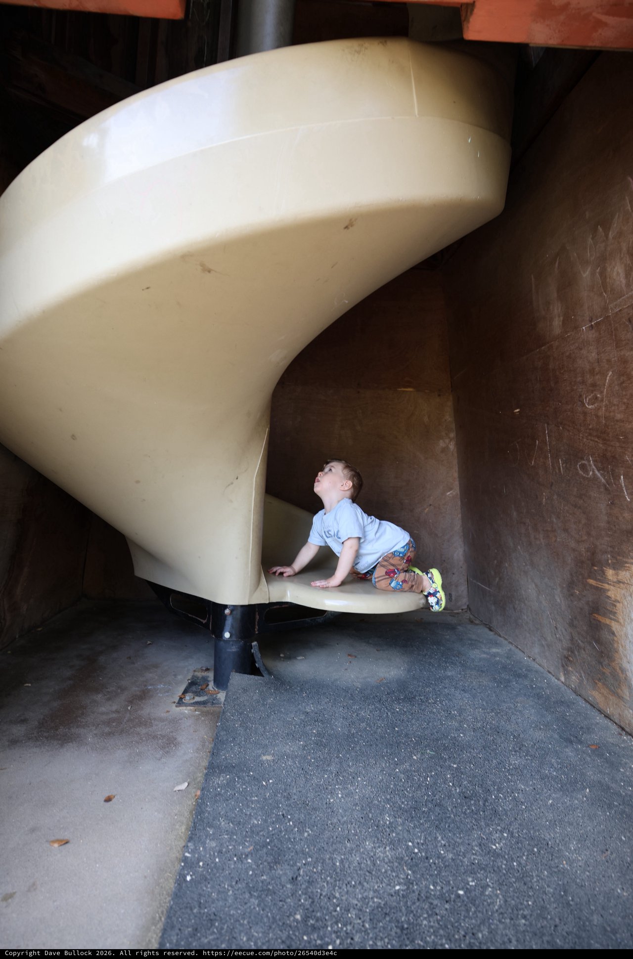 Young Child Climbing Curved Playground Slide at Fantasyland