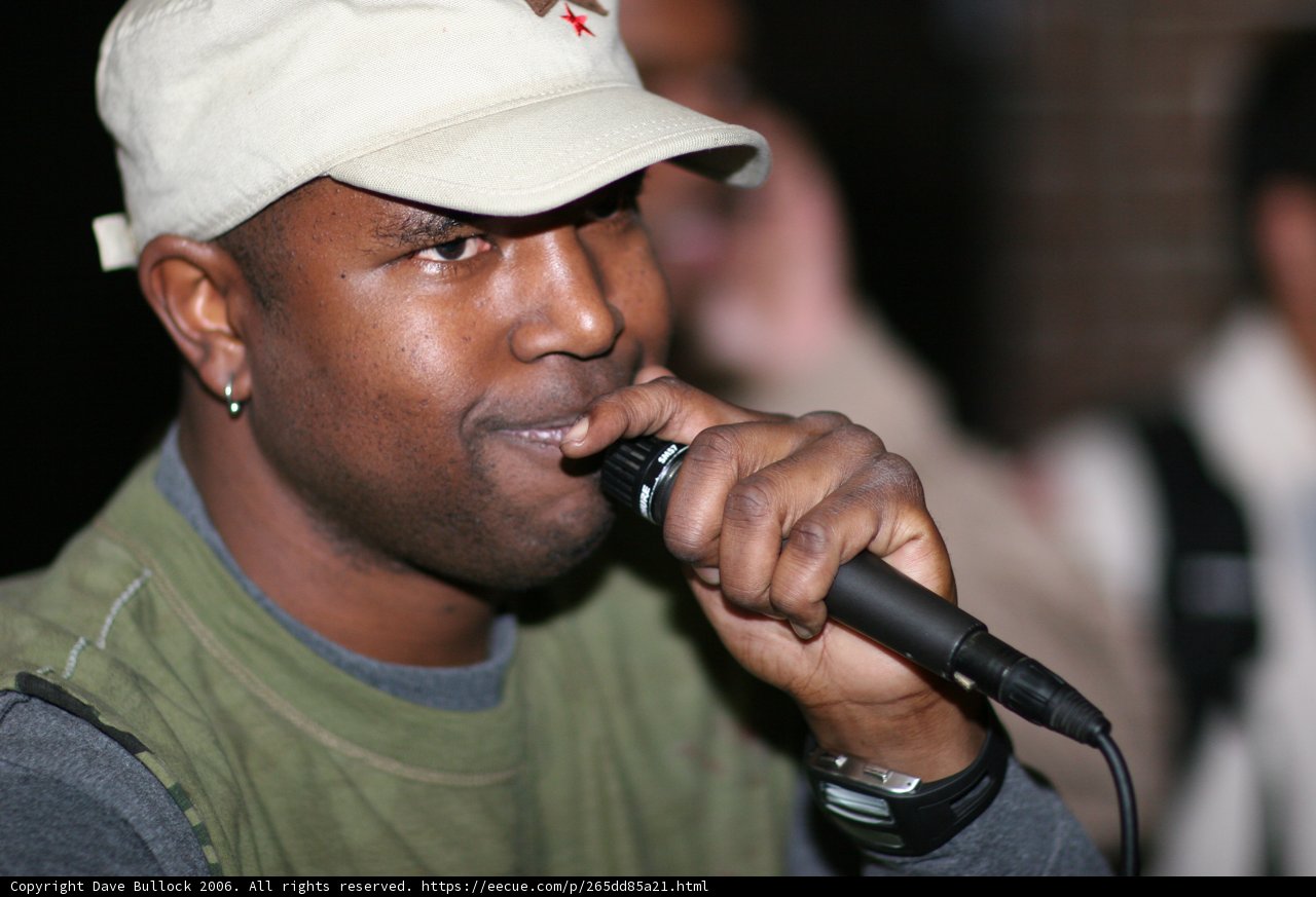 Entertainer with Microphone and Baseball Hat