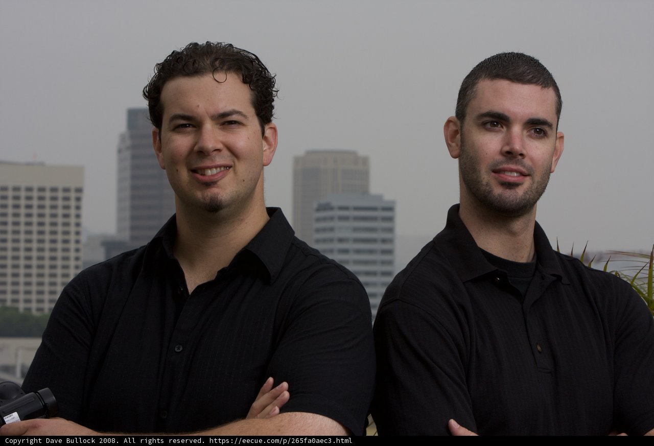 Two Men in Front of Skyscraper