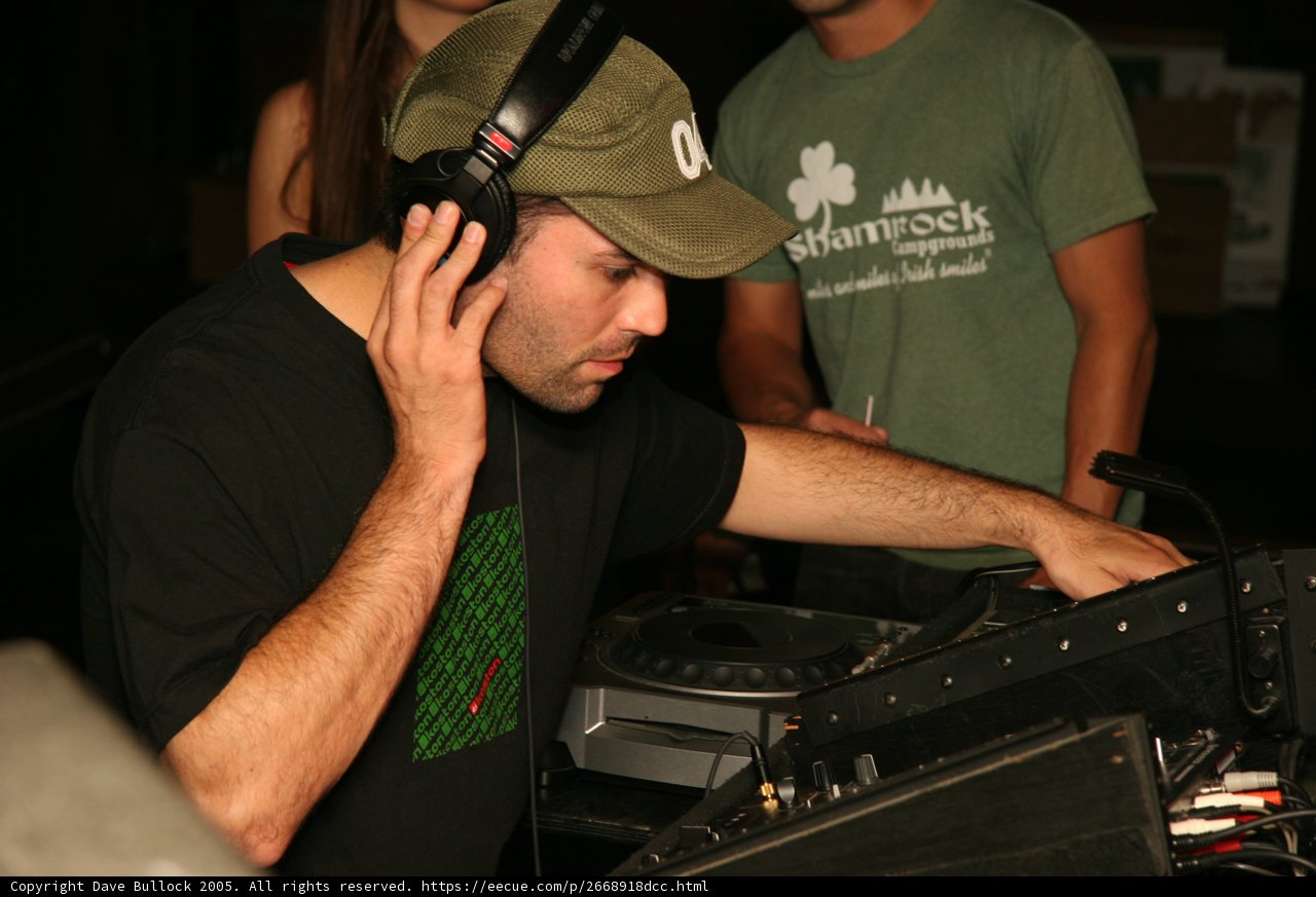 DJ in Green Shirt Spinning the Tables