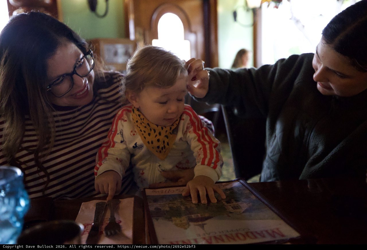 Family Moment Reading Together at Restaurant