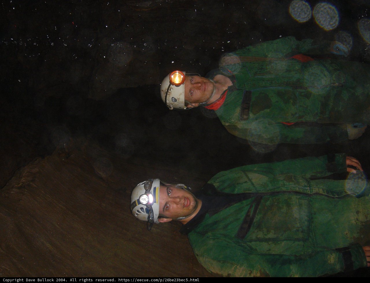Two Men Sporting Green Jackets and Headgear