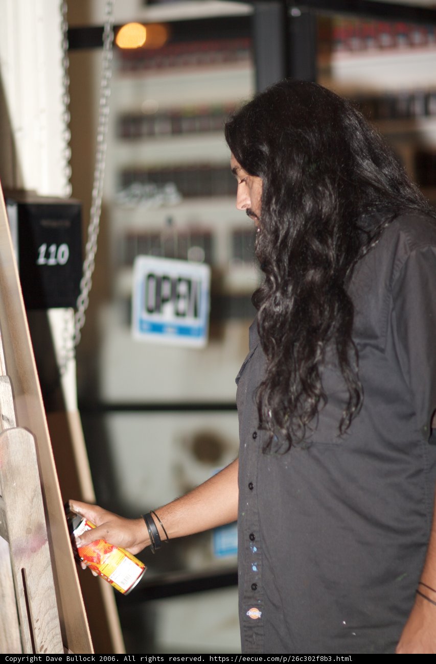 Long-haired Man in Front of Newsstand