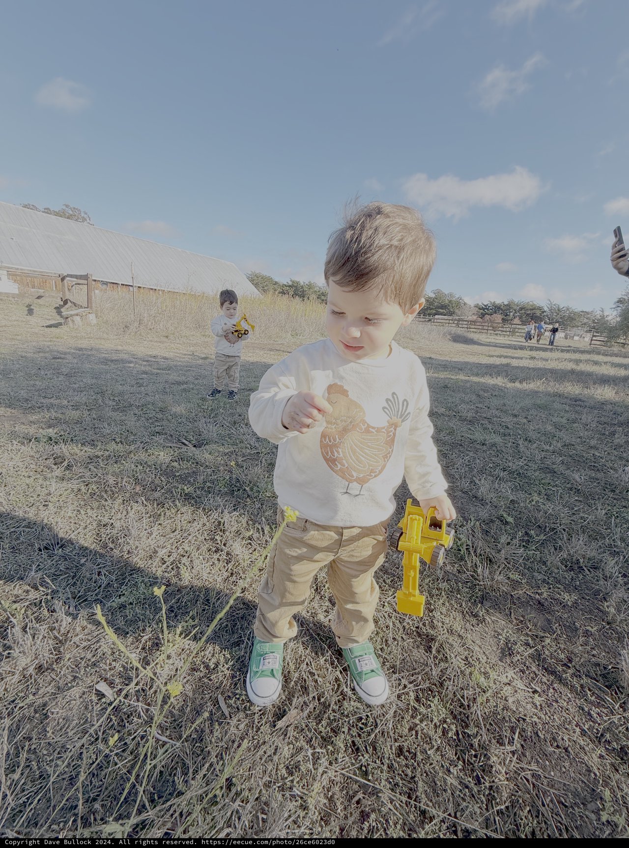 Young Boy Playing with Toy at Farm