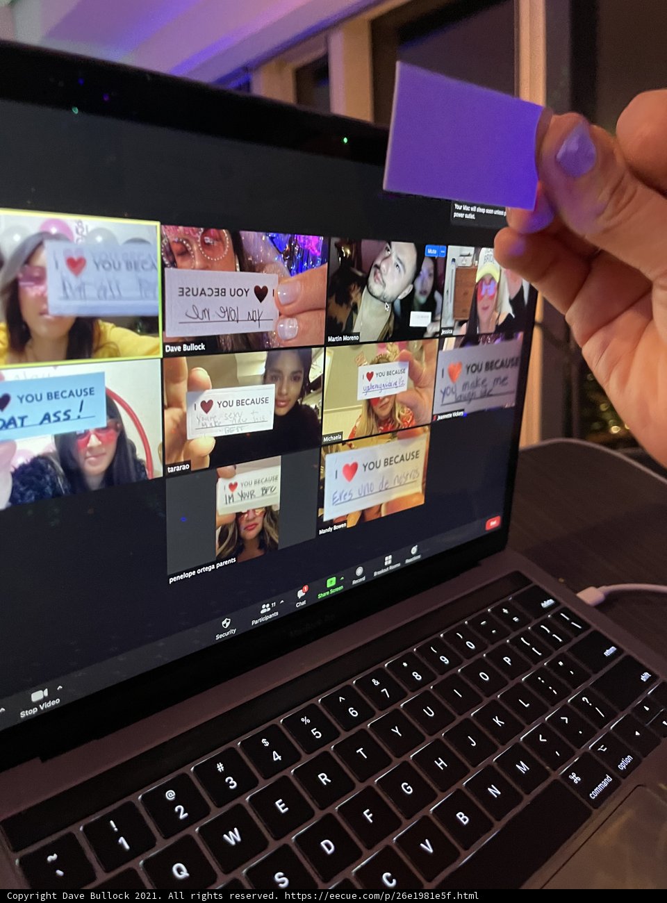 Holding a Card with a Picture of a Group of People