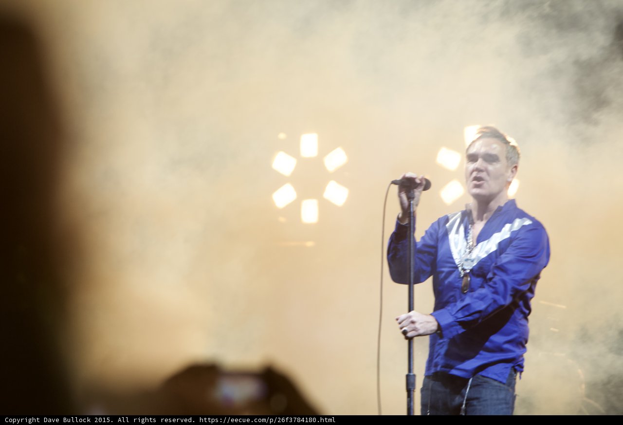 Morrissey Singing Blue Shirt White Stripe Mic Stand Gold Lights Circle Pattern Haze