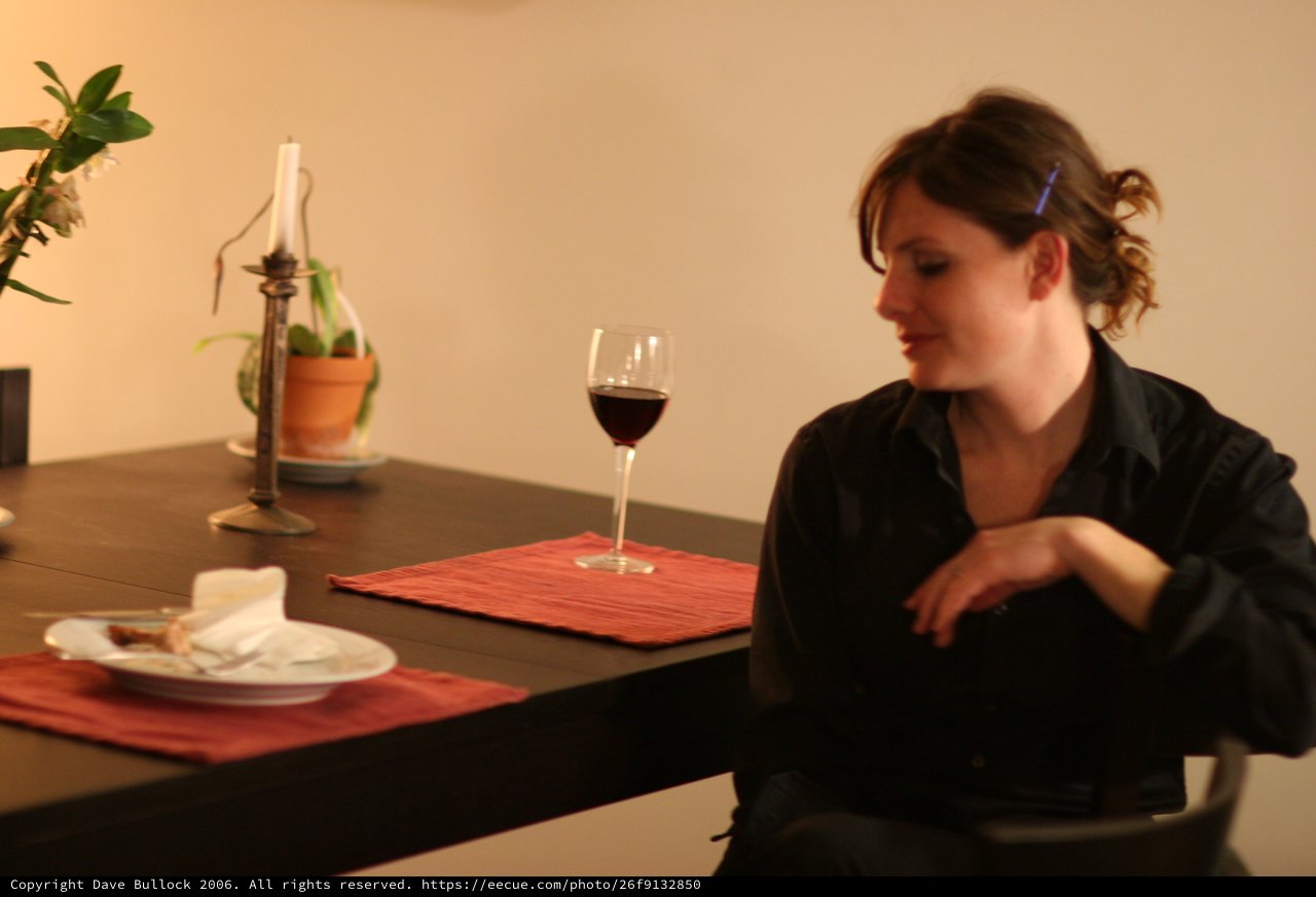 Woman Waiting Alone at Candlelit Dinner Table