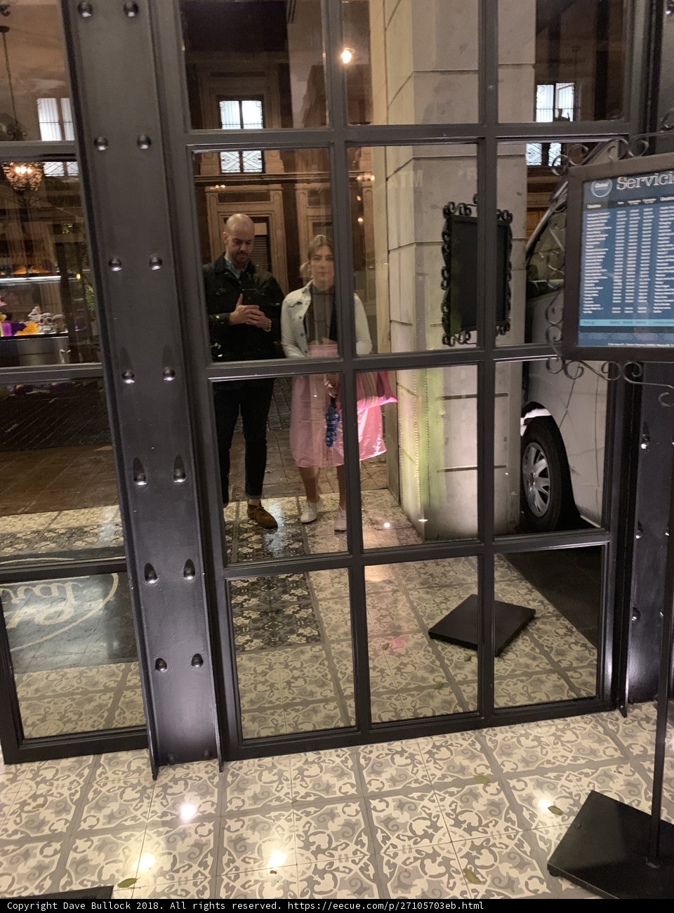 A Woman Standing in Front of a Glass Door