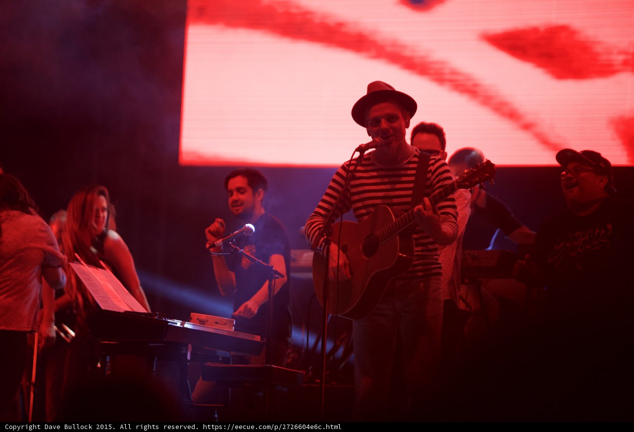 Belle and Sebastian Stuart Murdoch Smiling Acoustic Guitar Fedora Striped Shirt Fans Dancing Stage