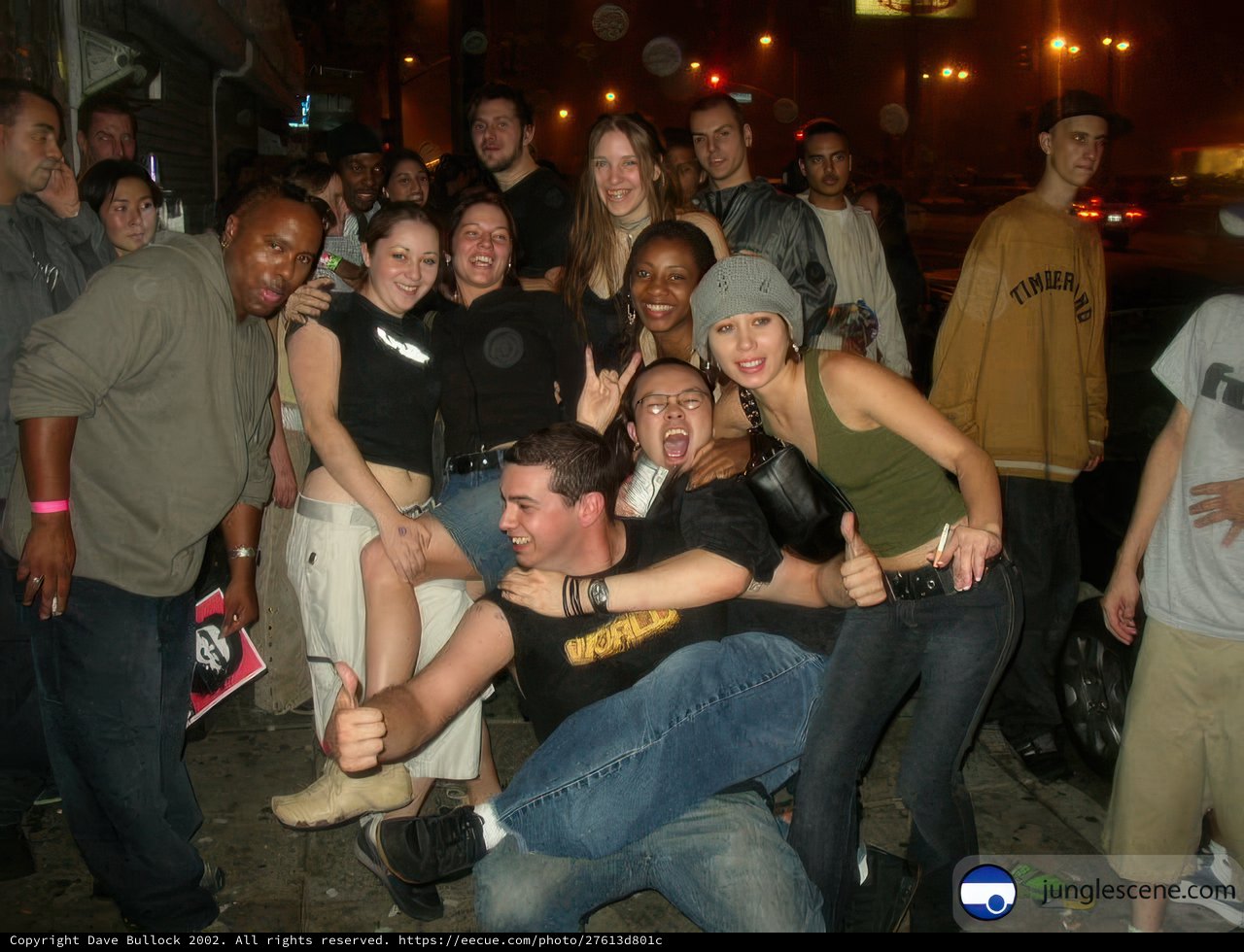 Urban Crowd Poses for Nightclub Photograph