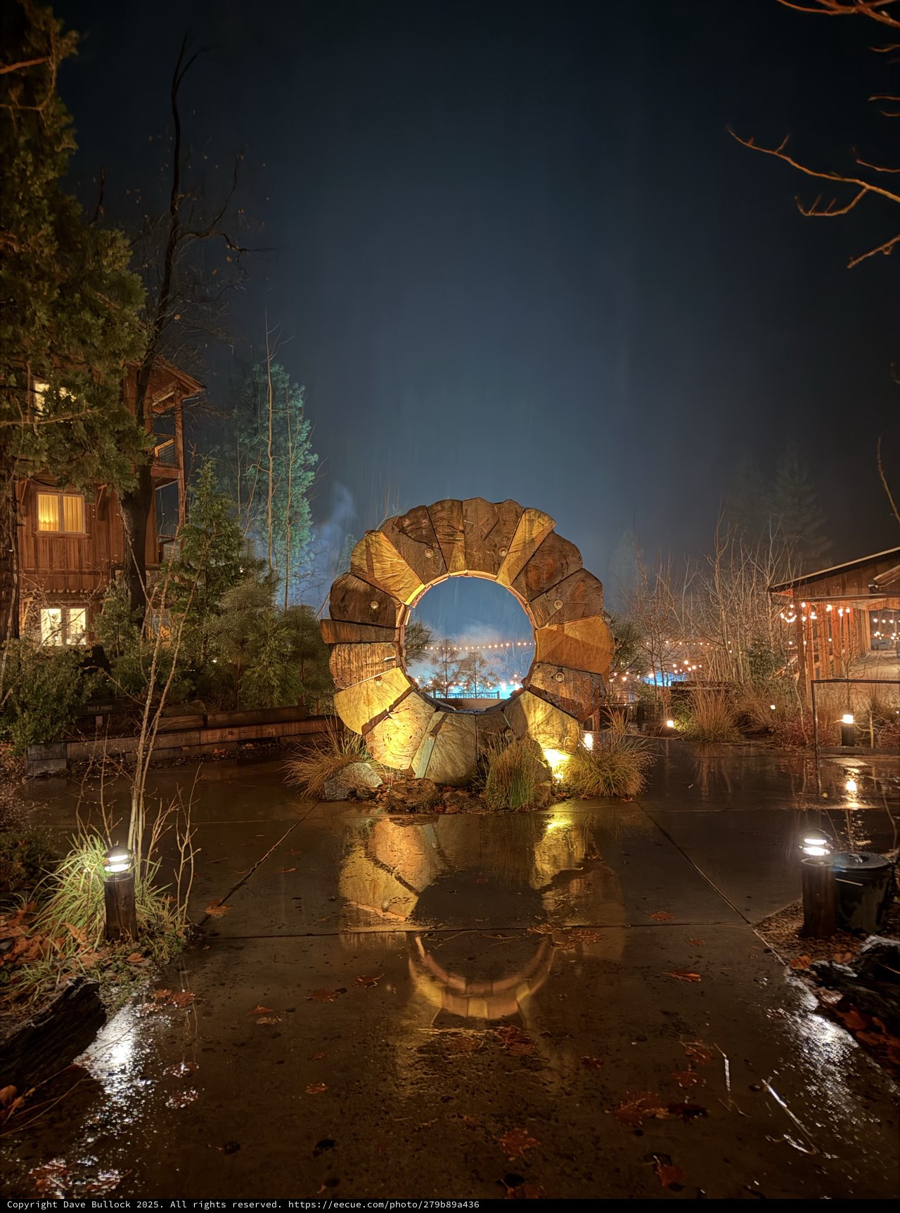 Wooden Portal Sculpture Glowing on a Rainy Night