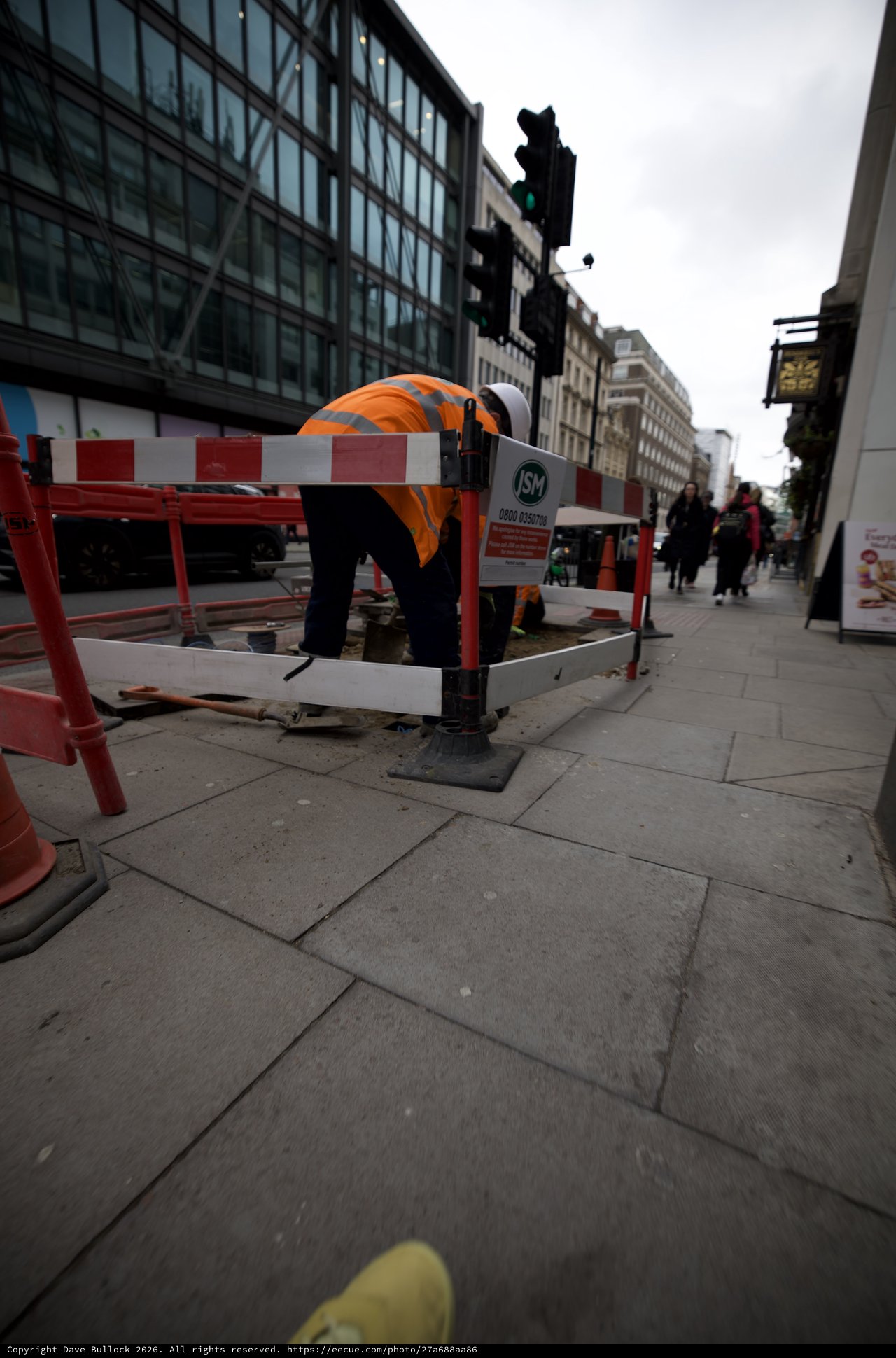 Construction Worker Maintaining Urban Sidewalk in London