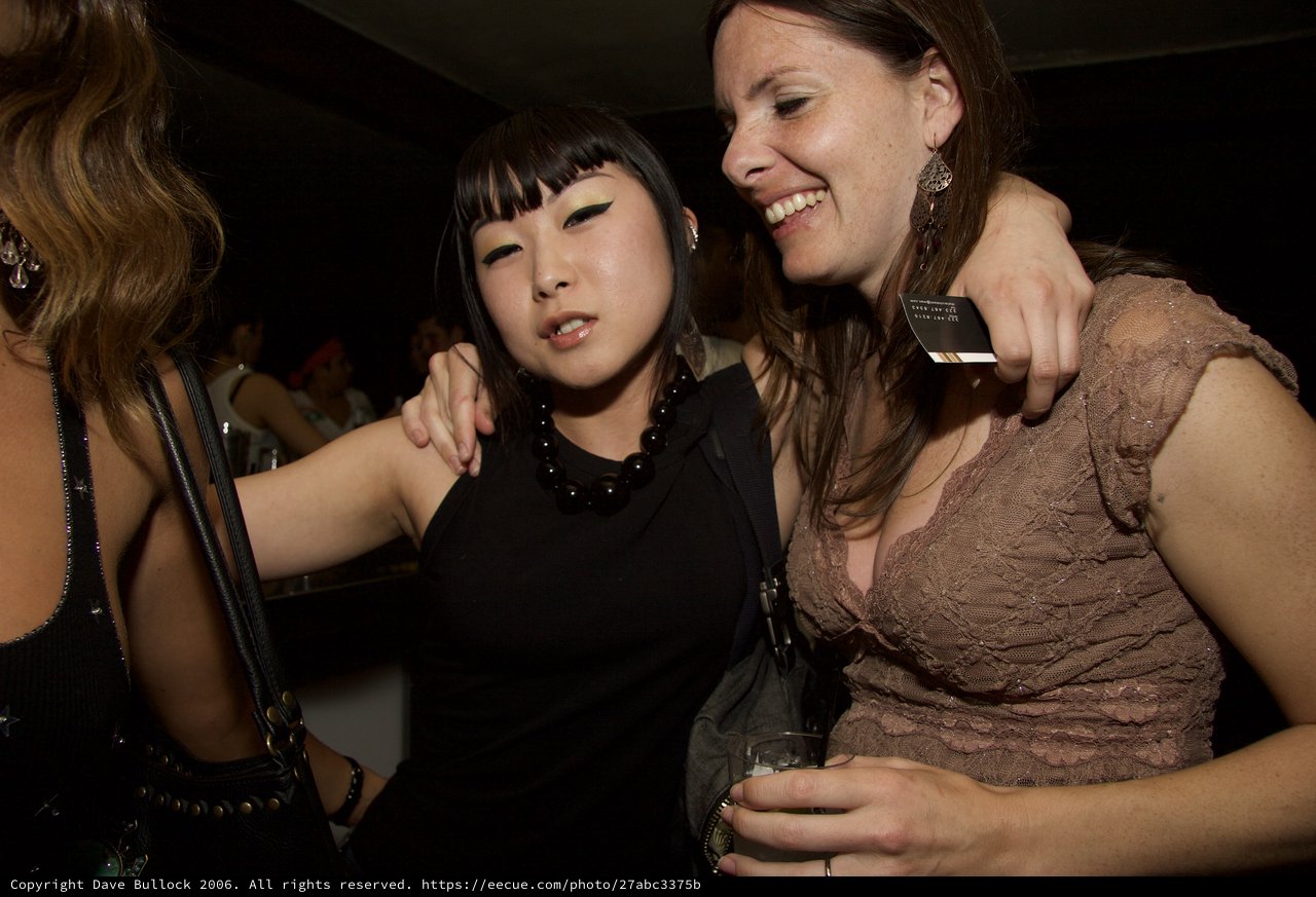 Two Friends Laughing Together at a Nightclub