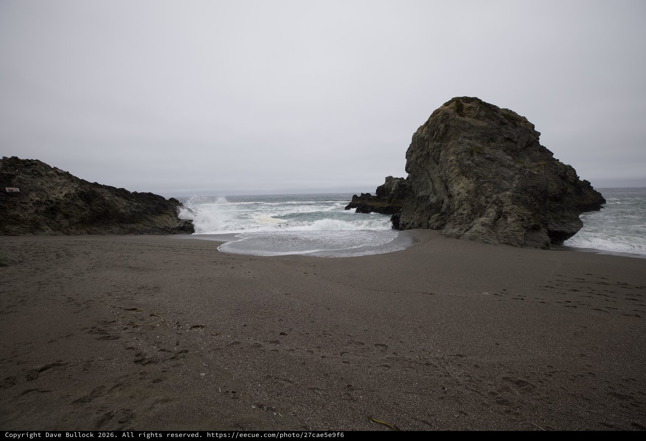 Moody Coastal Cove with Crashing Waves and Sea Stacks