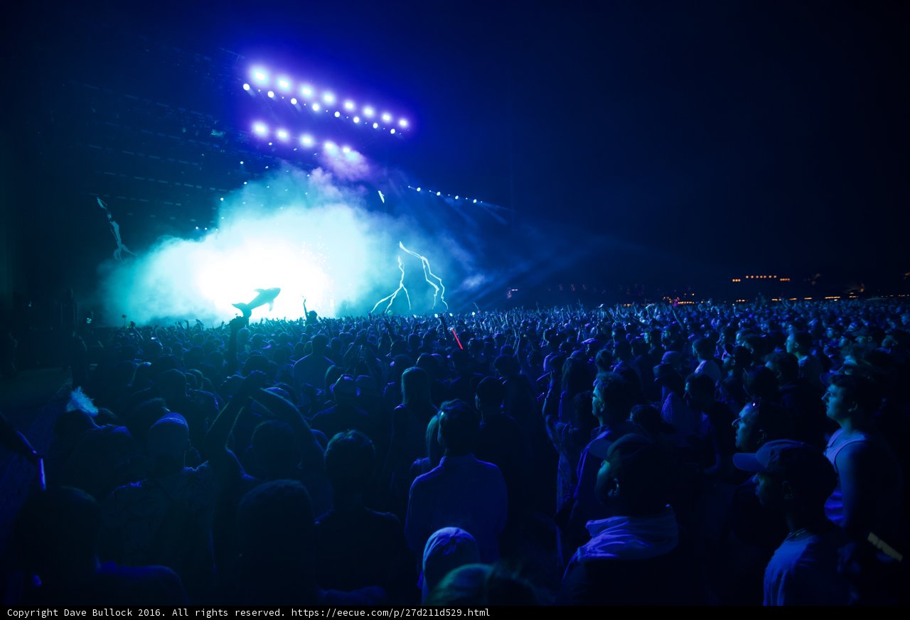 Blue Spotlight on the Rock Concert Crowd