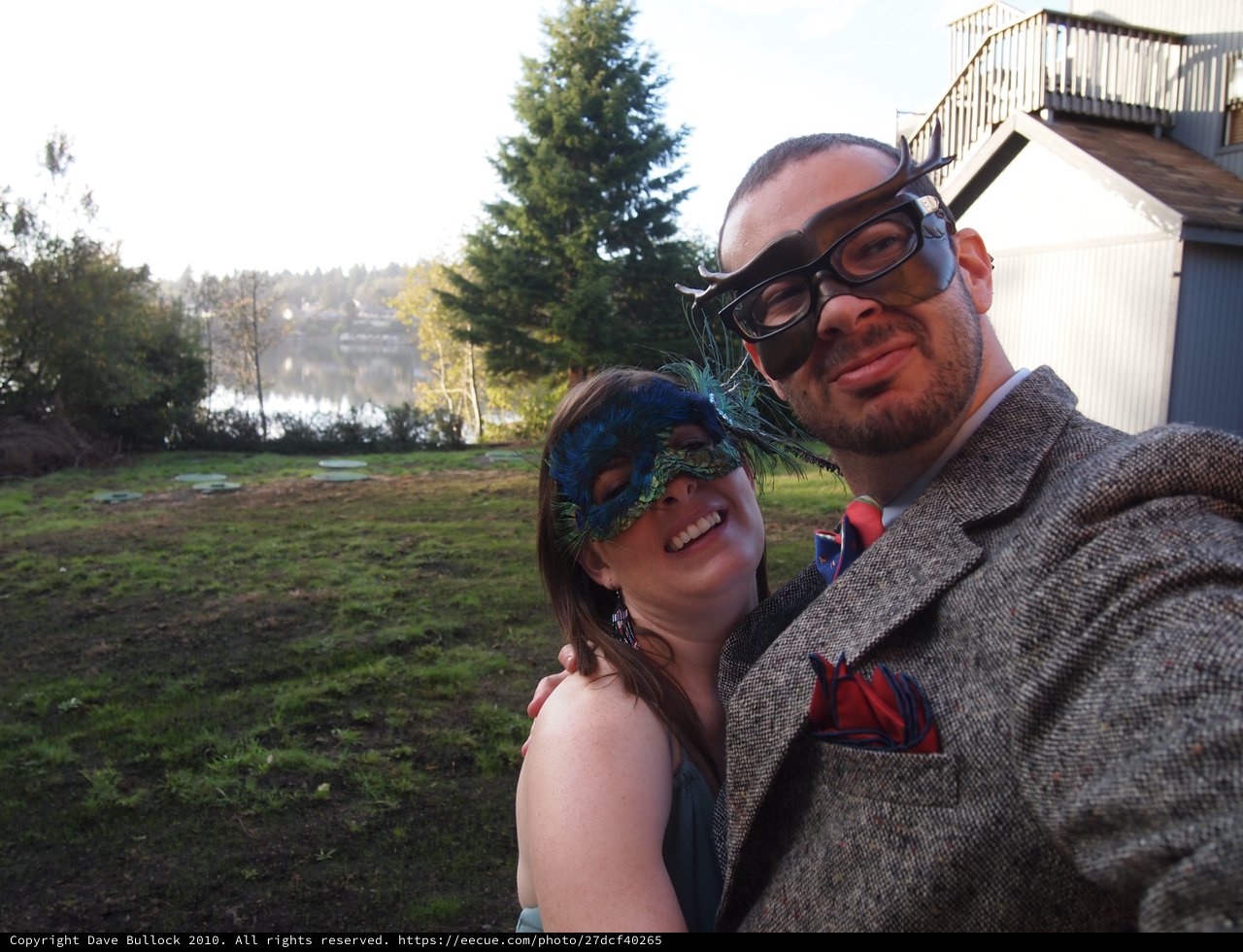 Masquerade Couple Posing by Lakeside Venue