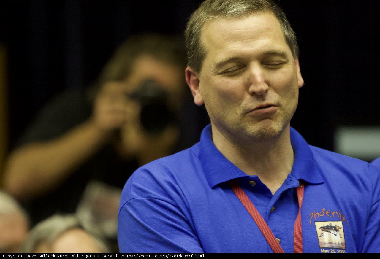 Man in blue shirt captivated by audience