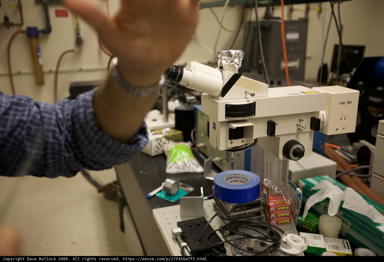 Lab Technician Analyzing Samples Under Microscope