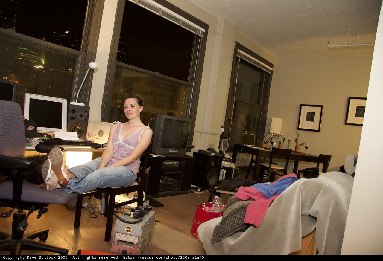 Woman Relaxing in Urban Loft Apartment at Night
