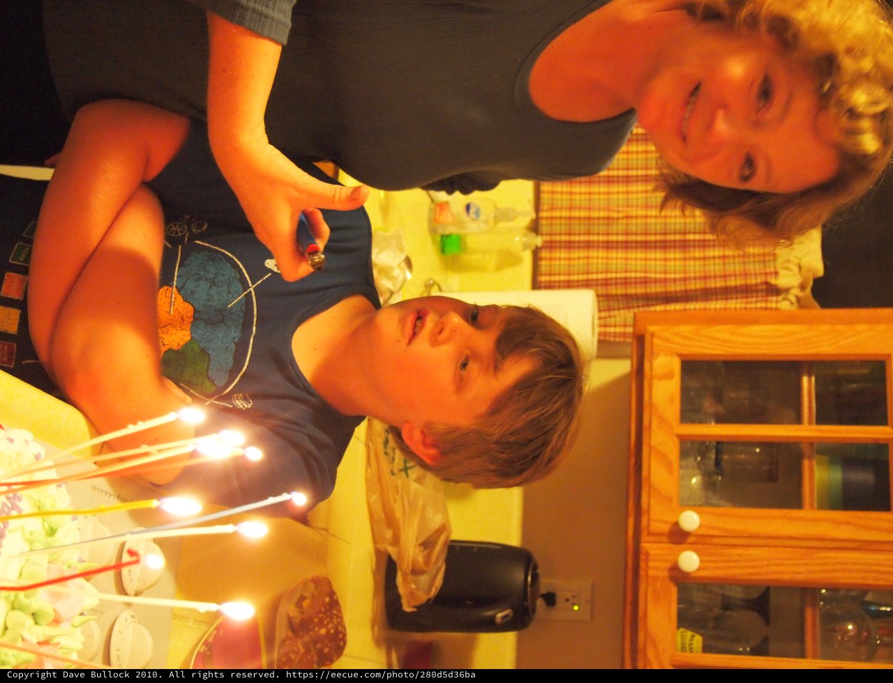 Birthday Boy Watches Candles Light Up His Cake