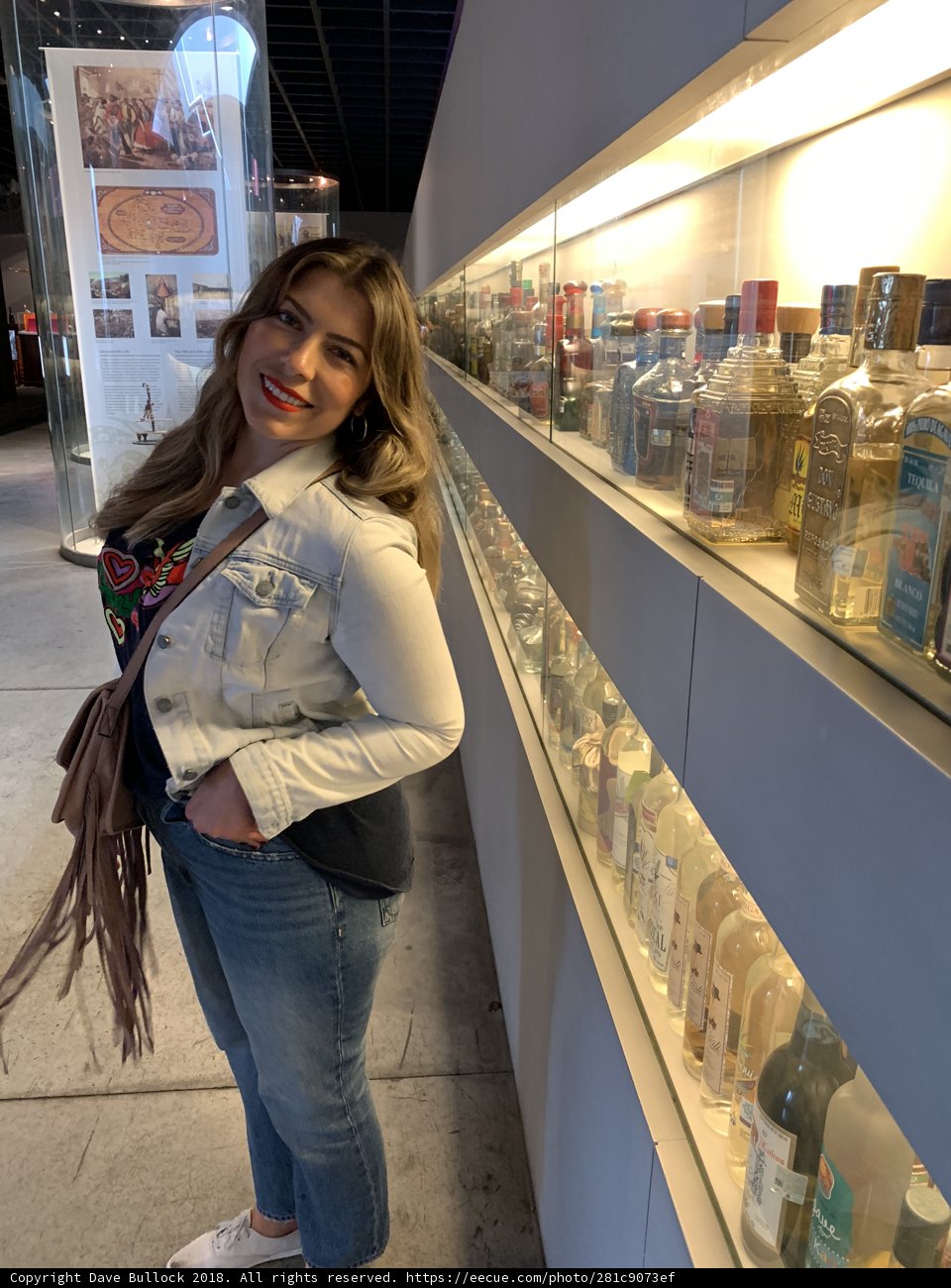 Girl in Jeans and Accessories Checking Out Beverages on Shelf