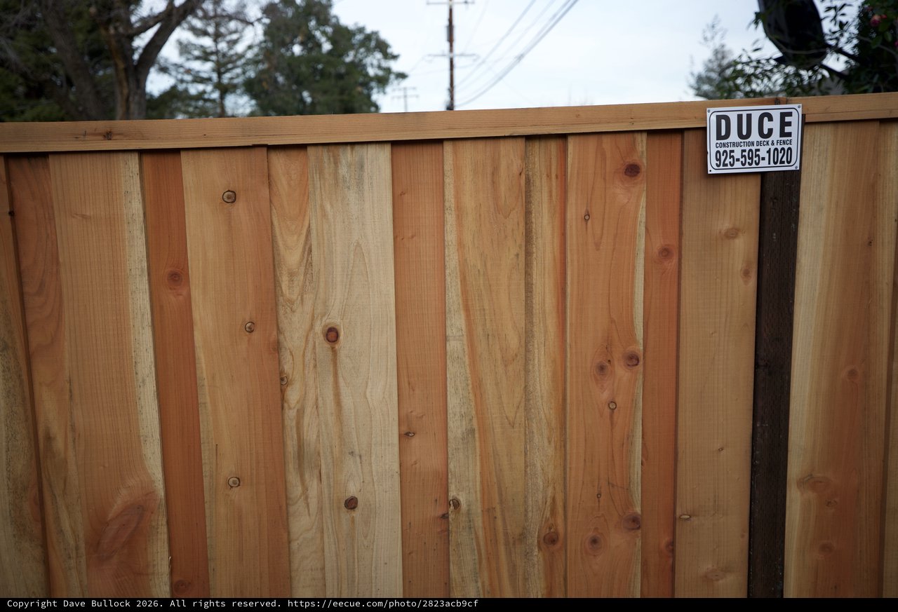 New Cedar Fence with Construction Company Sign