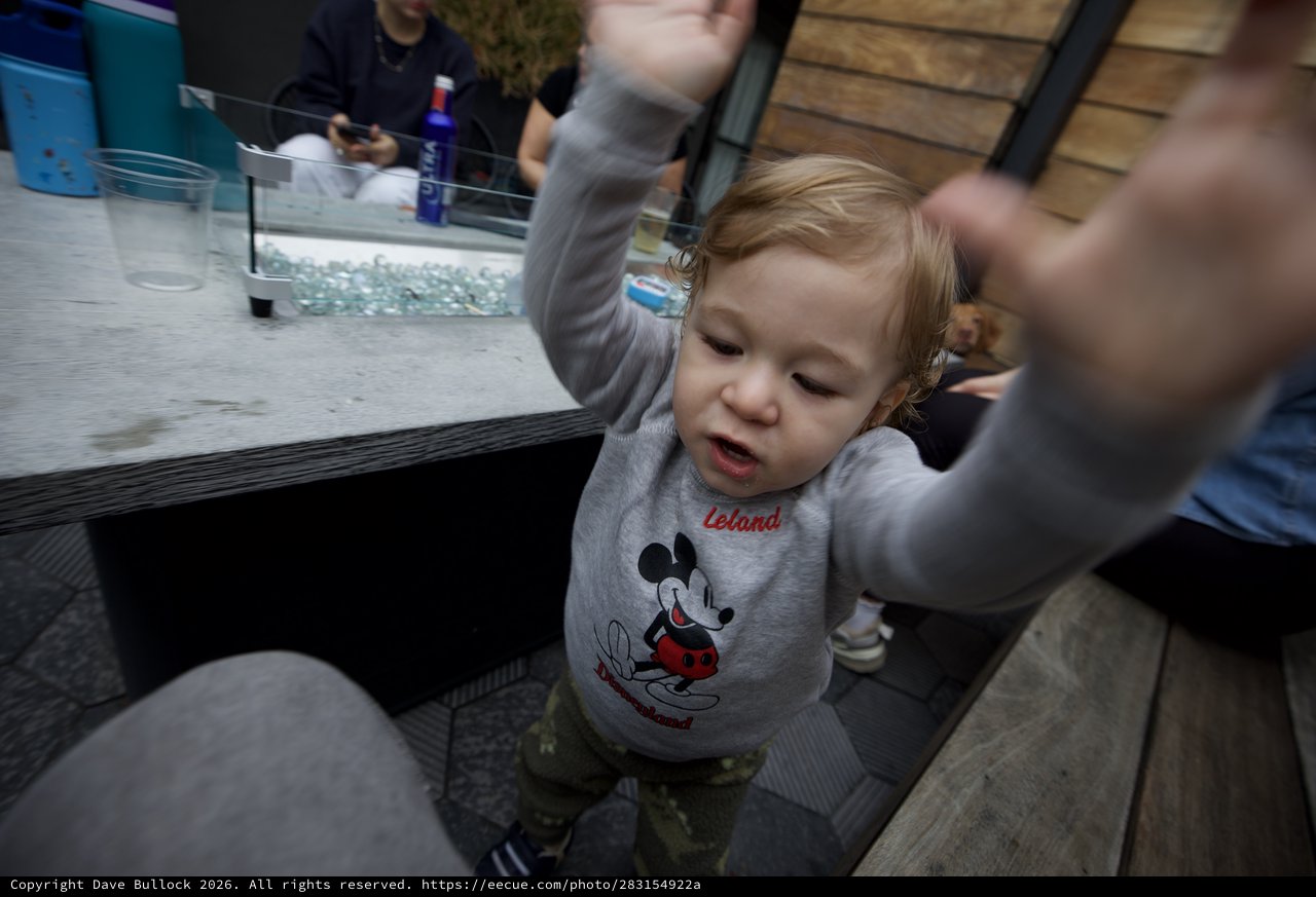 Toddler in Mickey Mouse Shirt Reaching Up