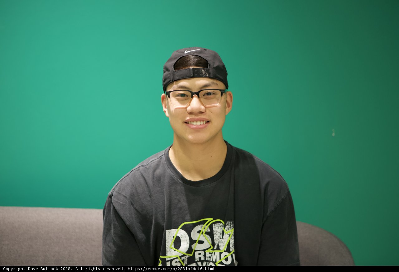 Smiling Teen in Black Hat and Glasses