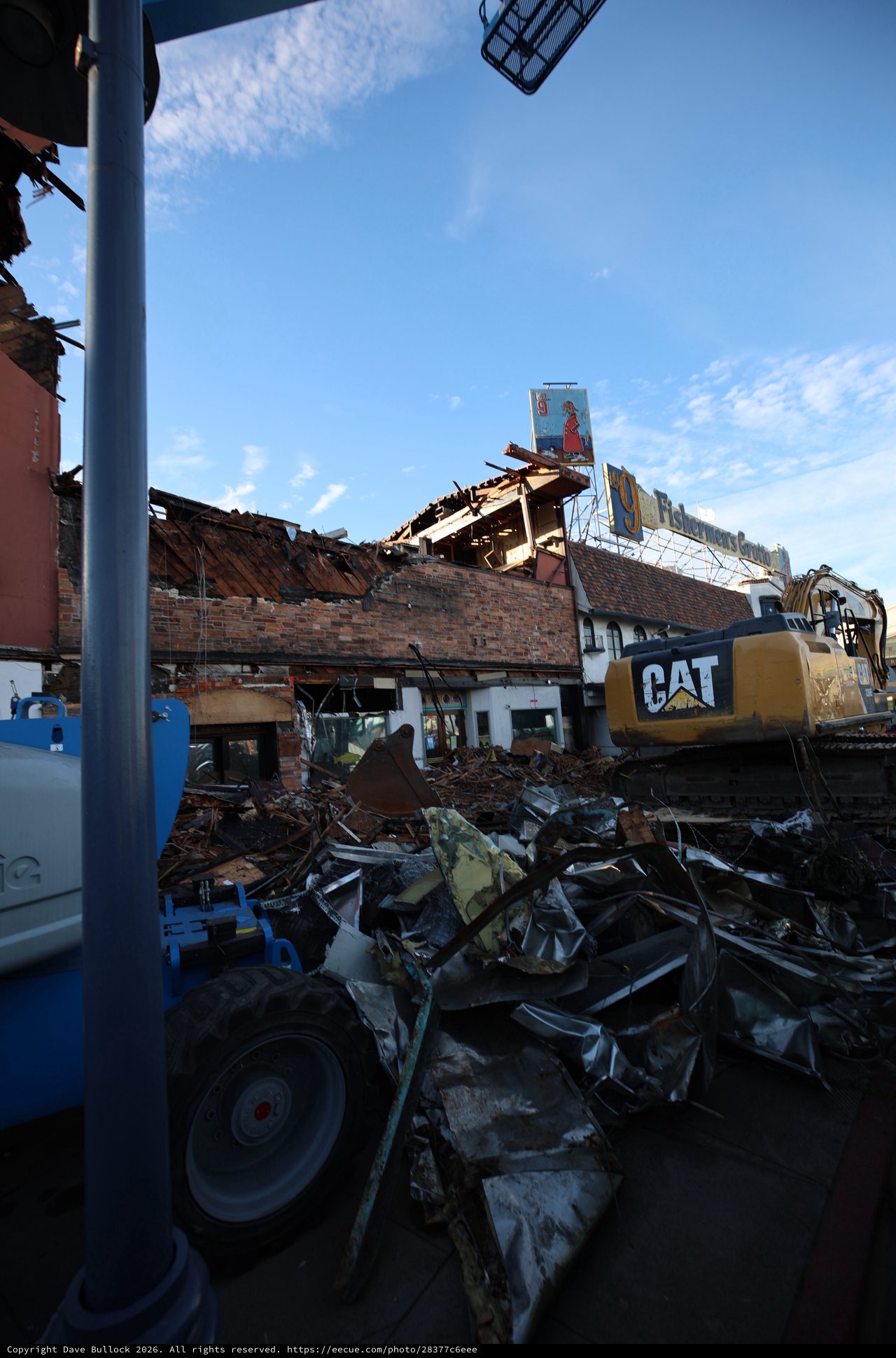 Demolition Site with CAT Excavator Clearing Debris