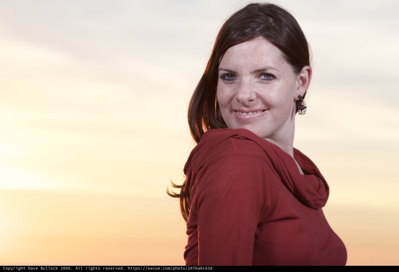 Smiling Woman Glances Back at Golden Sunset