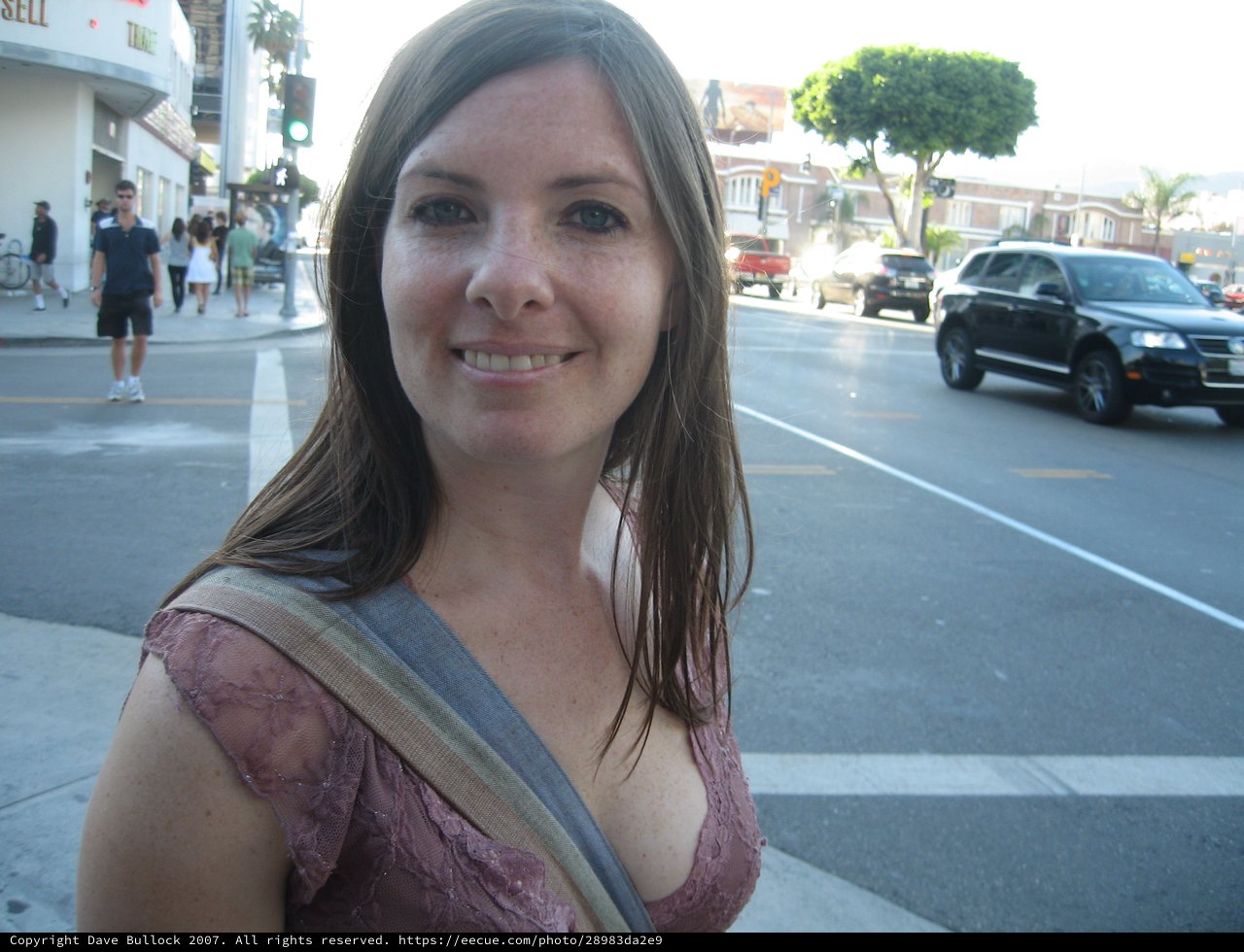 Young Woman Smiling at Urban Street Corner