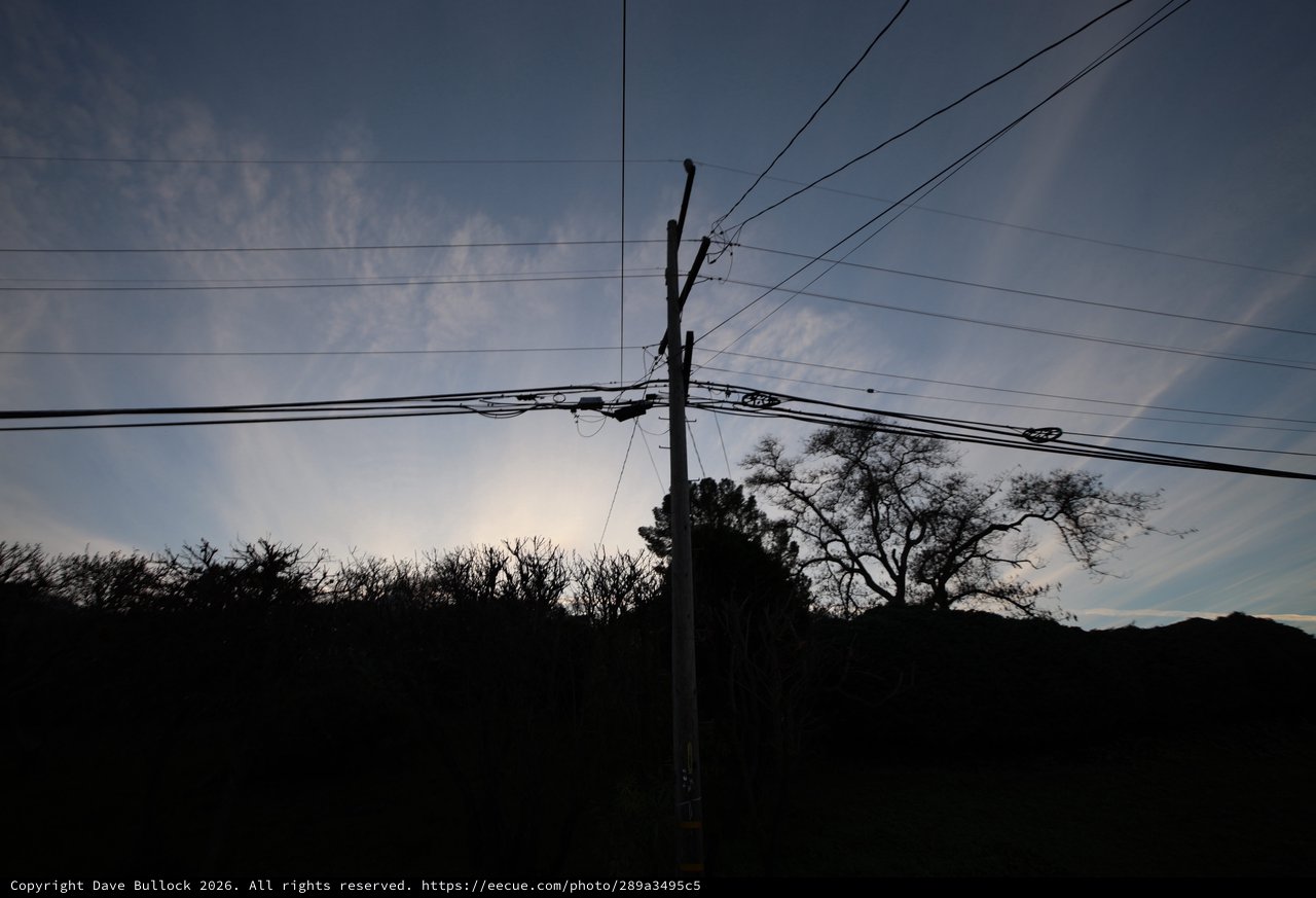Silhouetted Power Lines Against Twilight Sky