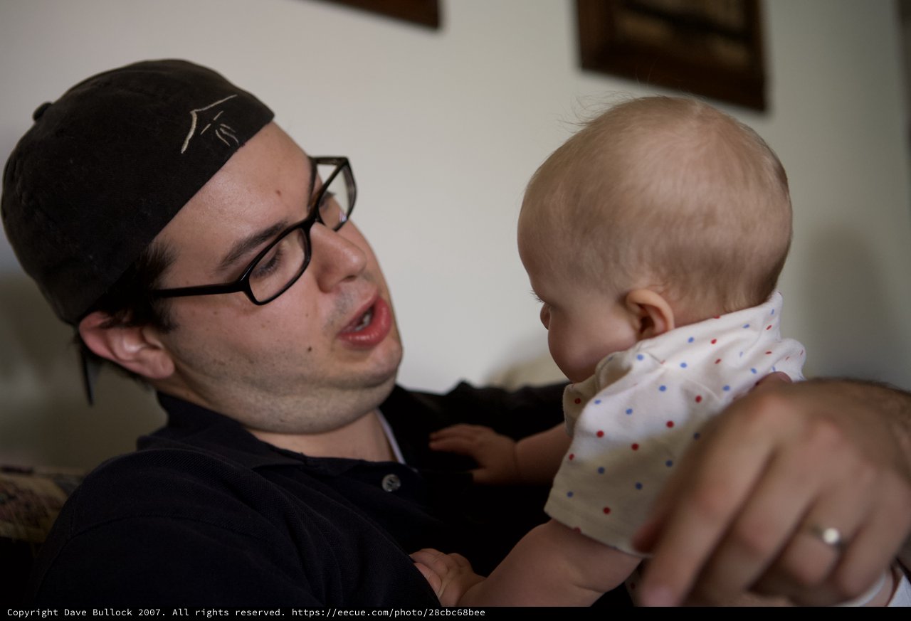 Young Father Bonds With Newborn Baby at Home