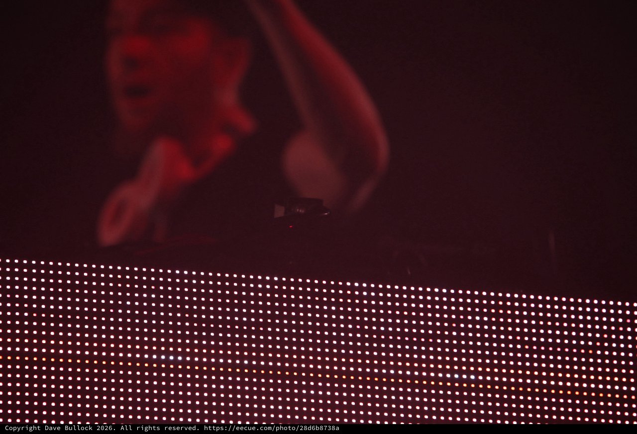 DJ Bathed in Red Light Above LED Stage