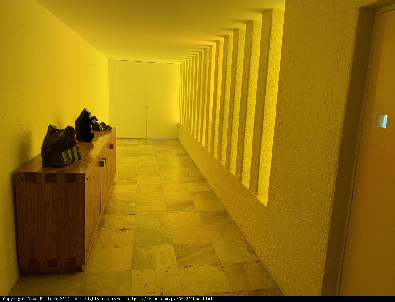 Sunny Yellow Hallway with Rustic Wooden Bench