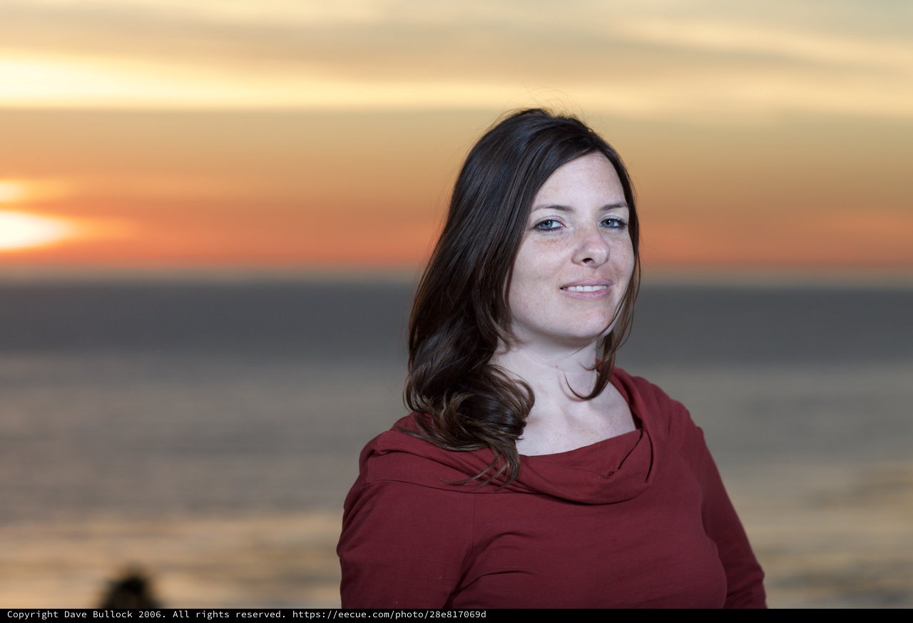 Woman Smiling Serenely at Ocean Sunset