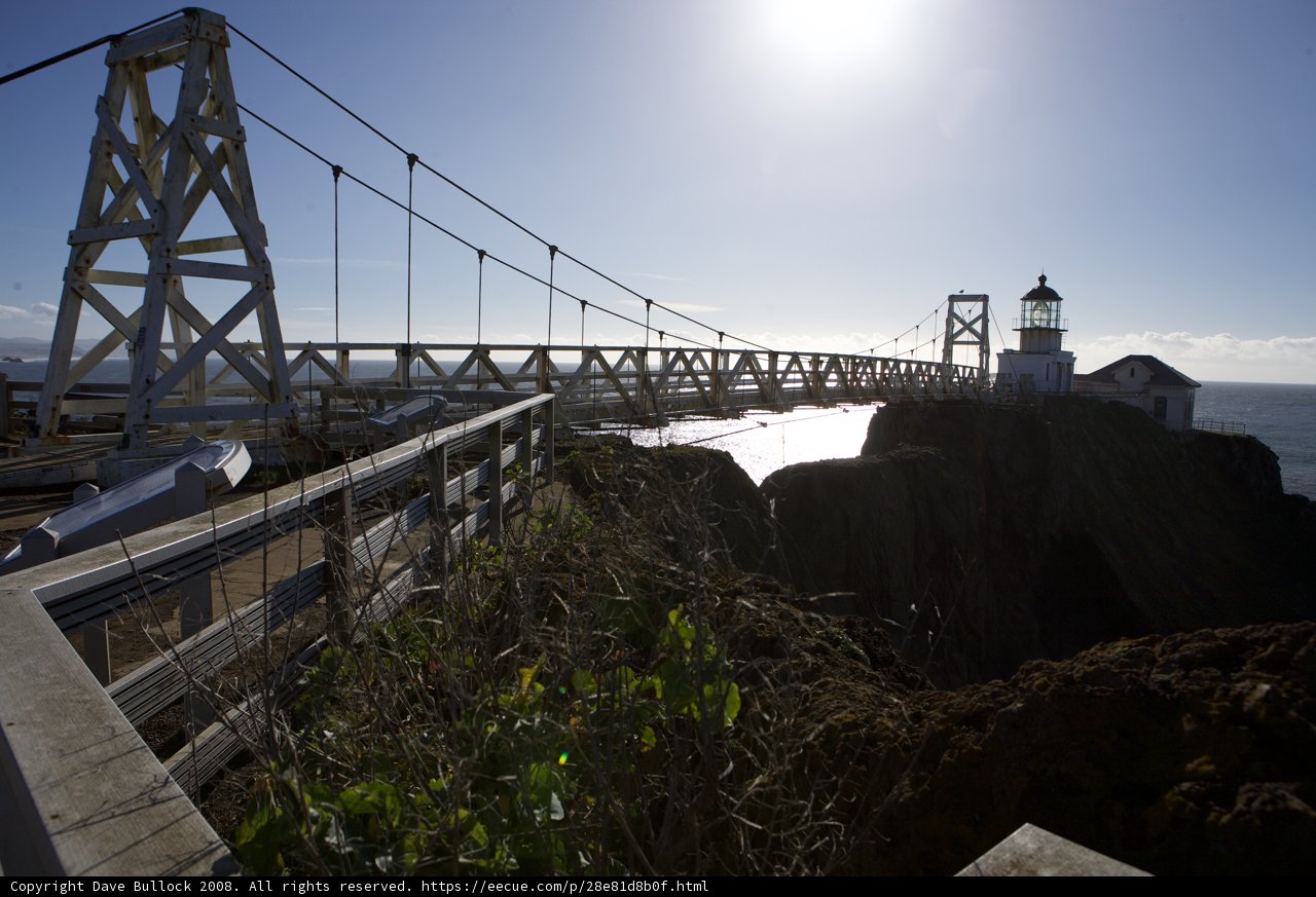 A Majestic Lighthouse and Suspension Bridge over the Ocean