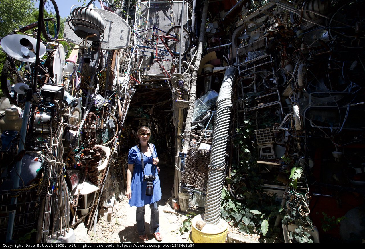 Woman Poses at Austin's Cathedral of Junk Entrance