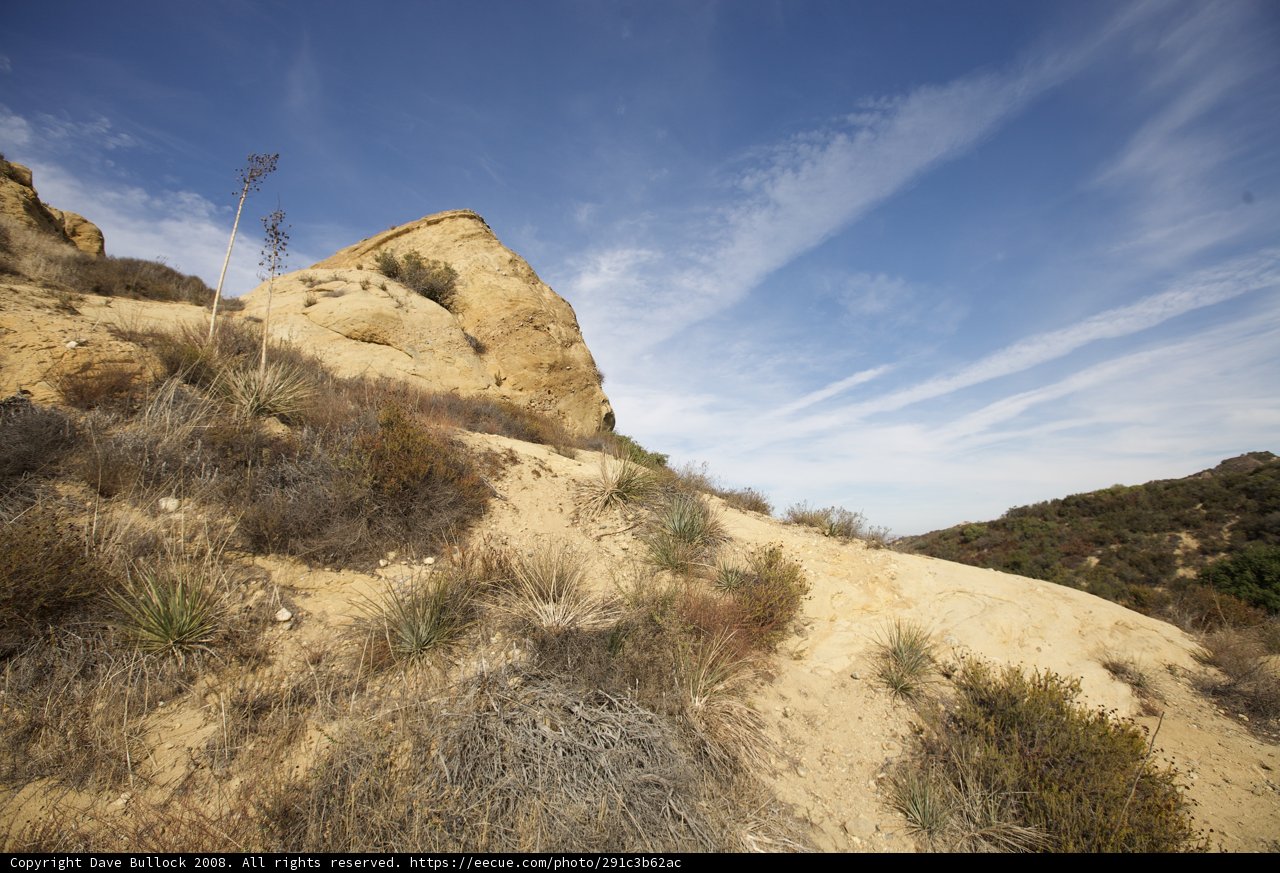 Majestic Rocky Hill amidst the Blue Sky and Clouds