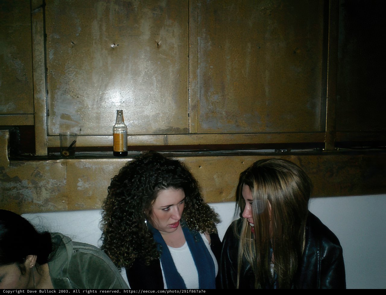 Two Women Enjoying Drinks in Stylish Jackets