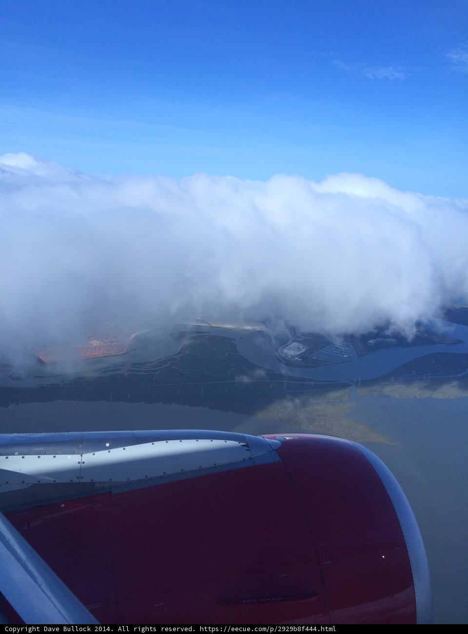 Flying over a Cloudy Water Body