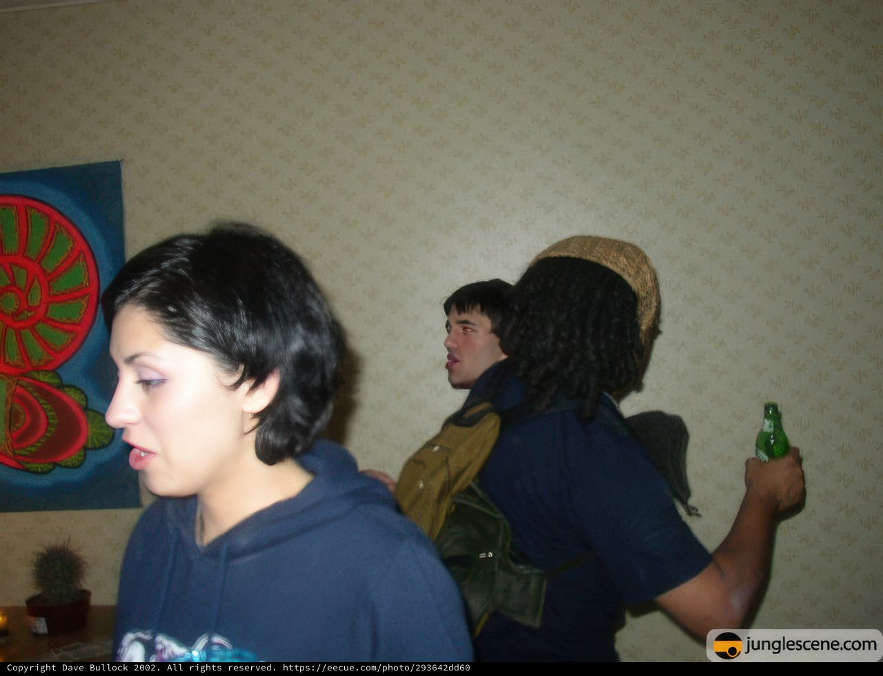 Dreadlocked Woman Enjoying a Drink with Friends