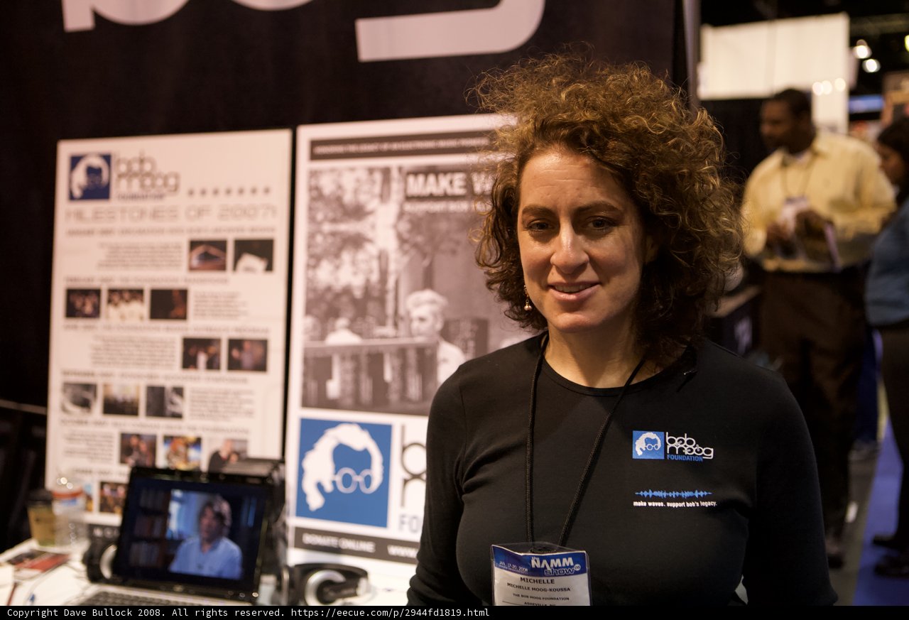 Woman showcasing computer hardware at NAMM booth