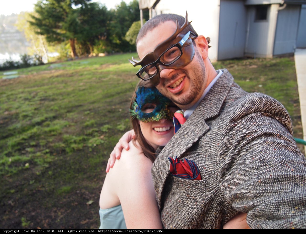Masked Couple Embracing at Outdoor Masquerade Party