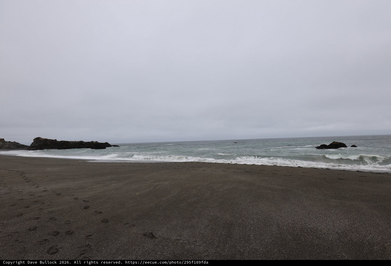 Overcast Solitude on a Dark Sand Beach