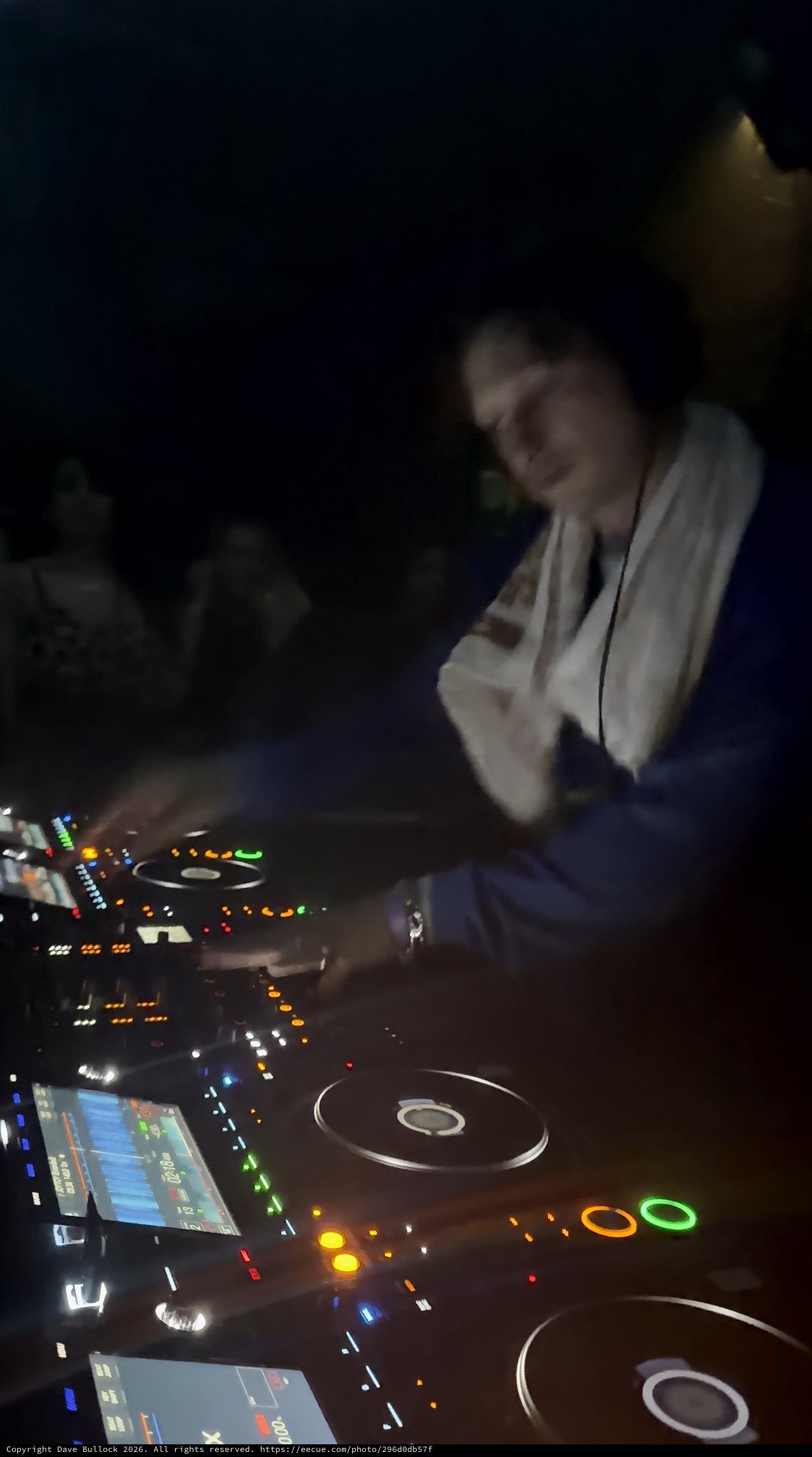 DJ Performing with Professional Pioneer CDJ Equipment at Night